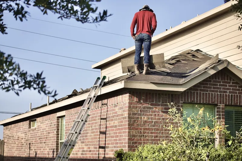 Professional roofer working on a residential roof in Hunters Harbor
